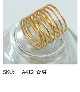 Detailed close-up of golden multi-layer twisted knot ring with a high-shine polished finish