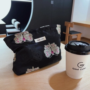 Elegant black brocade handbag with butterfly embroidery and simple wish label