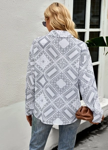 Detail of floral paisley pattern on back of white long sleeve blouse for women