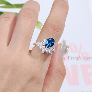 Close-up of S925 sterling silver ring with blue oval stone and marquise diamonds