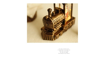 Detailed macro of vintage steam train lantern with bronze finish and festive glitter