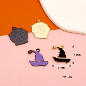 Detail showing colorful enamel witch hat and cauldron pendants with size dimensions