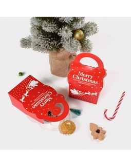 Detail of red Merry Christmas gift box with handle and festive holiday decorations