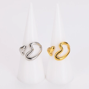 Minimalist gold and silver hollow heart rings with hammered texture on white cones