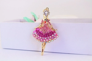 Close-up of golden ballerina brooch with sparkling pink and clear rhinestones