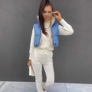 Close-up of blue quilted vest featuring stand collar and adjustable drawstring hem detail