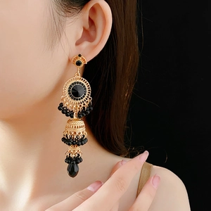 Detail view of vintage gold-layered earrings with black rhinestones and teardrop crystals
