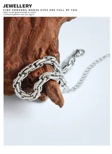 Detail of silver chunky chain bracelet with lobster clasp on vintage wood display