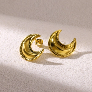 Detail of 18K gold-plated crescent earrings with textured hammered finish and polished surface