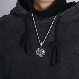 Close-up of a men's vintage silver titanium steel Celtic knot pendant on a twisted chain
