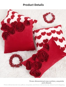 Detailed view of red velvet 3D rose and heart plush cushion covers for wedding decor