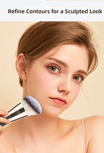 Close-up of dual-ended contour foundation brush applied to model face for seamless makeup