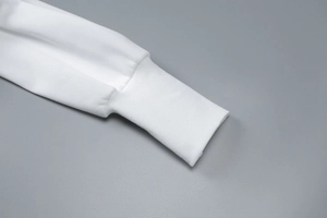 Detailed close-up of white ribbed cuffs on a stylish long-sleeved hooded cardigan jacket