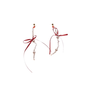 Long red ribbon bow earrings with cascading pearls and crystal drops on a white background