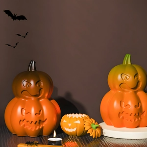 Detailed view of Halloween pumpkin candle holders and spooky ornaments on a festive table