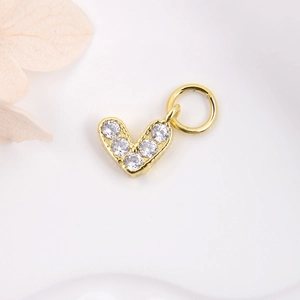 Detailed close-up of golden V-shape heart pendant with sparkling colorful zircon stones