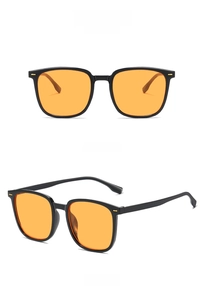 Close-up of retro square sunglasses with a glossy black frame and orange lenses