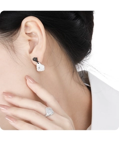 Macro view of irregular silver and black lava texture earrings and matching ring set