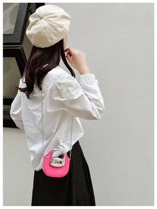 Mini rose red crossbody bag featuring a silver metal handle and sleek chain strap