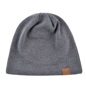 Close-up of dark grey knitted beanie showing detailed texture and F&S leather patch