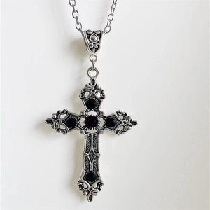 Gothic vintage silver cross pendant necklace featuring five black gemstones on a white background