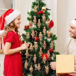 Nutcracker wooden ornaments hanging on a Christmas tree with festive holiday decorations