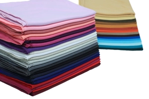Detailed stack of multi-color mercerized cotton jersey scarves showing fabric texture