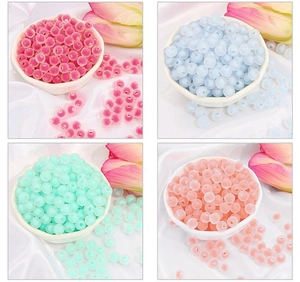Detail of colorful round acrylic beads in pink, blue, and mint green for DIY jewelry