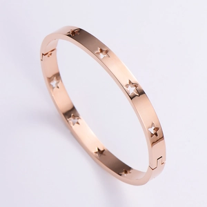 Detail of rose gold stainless steel hollow star bracelet with a side hinge clasp