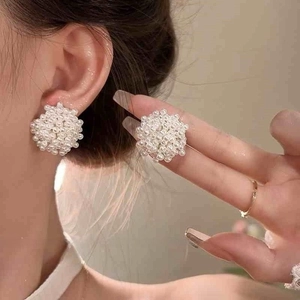 Elegant floral cluster pearl stud earrings with French vintage style on female model