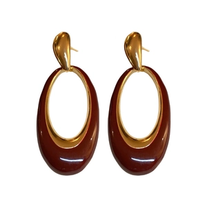 Vintage gold oval drop earrings with deep burgundy enamel on a clean white background