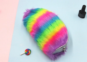 Detail of rainbow plush pencil case showing soft colorful fur and silver metallic zipper edge