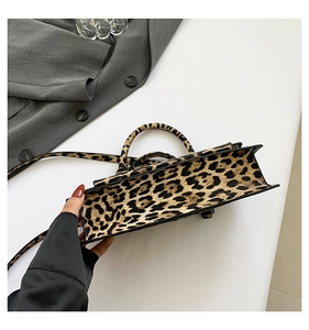 Detailed top view of a structured leopard print PU leather crossbody bag with handles