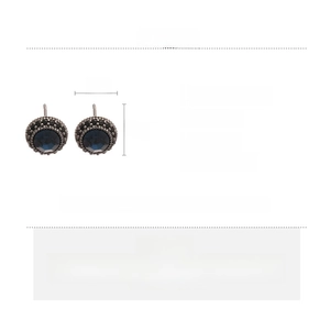 Detail view of vintage round stud earrings with blue center stone and black zircon border