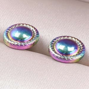 Detailed macro view of iridescent rainbow stud earrings with twisted rope border design