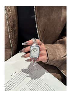 Silver square dial ladies watch with beaded bracelet strap shown in a lifestyle setting