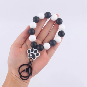 Black and white silicone bead wristlet keychain with a cute cartoon cat paw charm