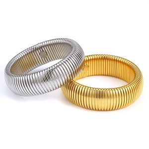Detailed view of elastic titanium steel spiral bracelets in gold and silver finish