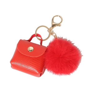 Red snake-embossed mini bag keychain with fluffy pompom and gold-tone metal clasp
