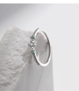 Close-up of s925 silver ring with white and turquoise crystal floral cluster setting