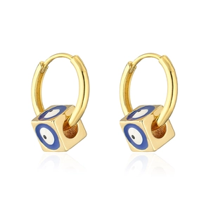 Detailed close-up of 18K gold earrings with blue evil eye cube charms on a white background
