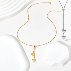 Detail of adjustable double heart Y-shaped necklaces in polished gold and silver steel