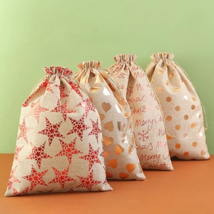 Set of four Christmas burlap gift bags with drawstring and festive metallic prints