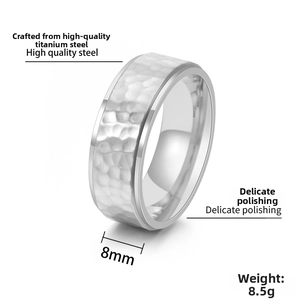 Macro shot of 8mm titanium steel ring featuring handcrafted hammered texture and polished edge