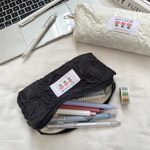 Minimalist embossed large capacity pencil cases in black and white with woven label