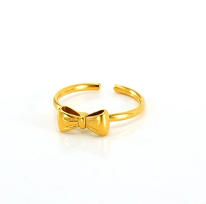 Detail of gold bow ring featuring a matte finish and adjustable open band design
