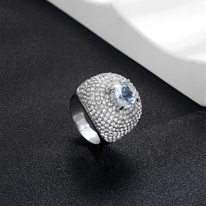 Macro shot of silver Cuban ring with large central zircon and pavé diamond setting