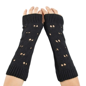 Long black knitted arm warmers featuring unique butterfly cutout designs and fingerless style