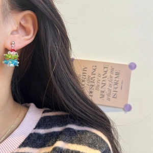 Detailed view of handmade beaded Christmas tree earrings with colorful crystals