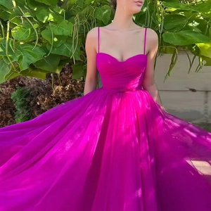 Magenta spaghetti strap tulle evening gown with pleated bodice and flowing long skirt